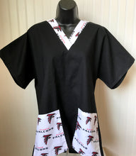 Load image into Gallery viewer, Solid Black Scrub Top with Atlanta Falcons Football Fabric on *Neck Band & Pocket Options* Medical Scrub Top Unisex Style Shirt for Men & Women