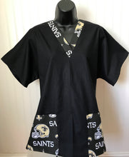 Load image into Gallery viewer, Solid Black Scrub Top with New Orleans Saints Football Fabric on *Neck Band & Pocket Options* Medical Scrub Top Unisex Style Shirt for Men & Women