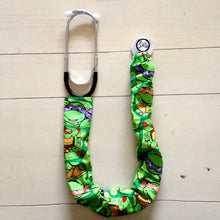 Load image into Gallery viewer, TMNT Teenage Mutant Ninja Turtles Donatello Michaelangelo Raphael Leonardo Faces Green Fabric Stethoscope sock cover for Medical Professionals