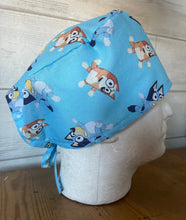 Load image into Gallery viewer, BLUEY &amp; BINGO CARTOON Blue Medical Scrub Caps Unisex Men &amp; Women Tie Back and Bouffant Hat Styles
